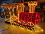 Train Car Photo Op with Garland Holiday Light Display